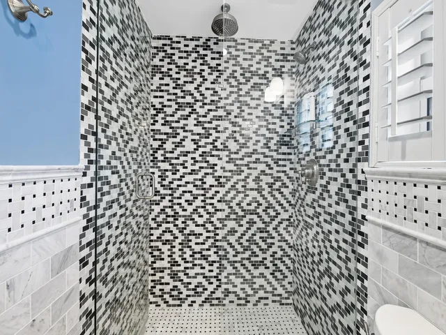 a bathroom with a black white checkered floor