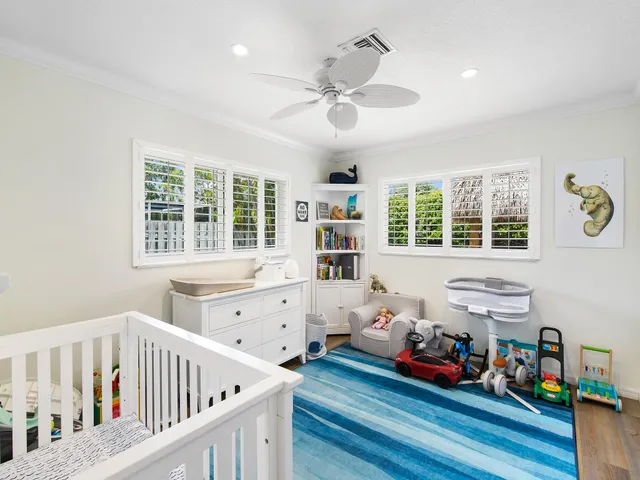 a bedroom with furniture and a large window
