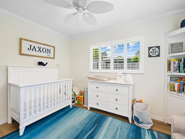 a view of a bedroom with furniture and wooden floor