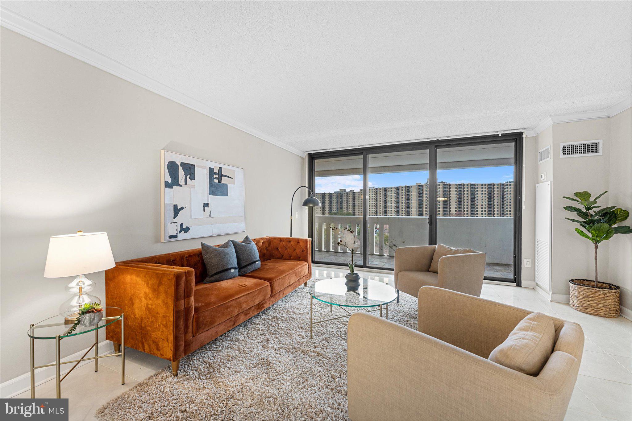6101 Edsall Road, Unit 1402 Alexandria, VA 22304 - Photo 1 of 37 a living room with furniture and a large window