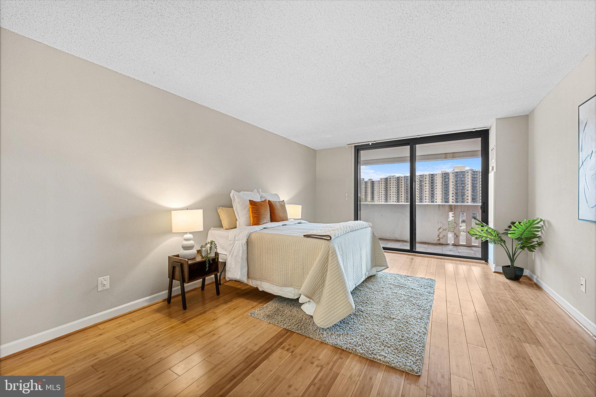 6101 Edsall Road, Unit 1402 Alexandria, VA 22304 - Photo 12 of 37 a spacious bedroom with a bed and wooden floor