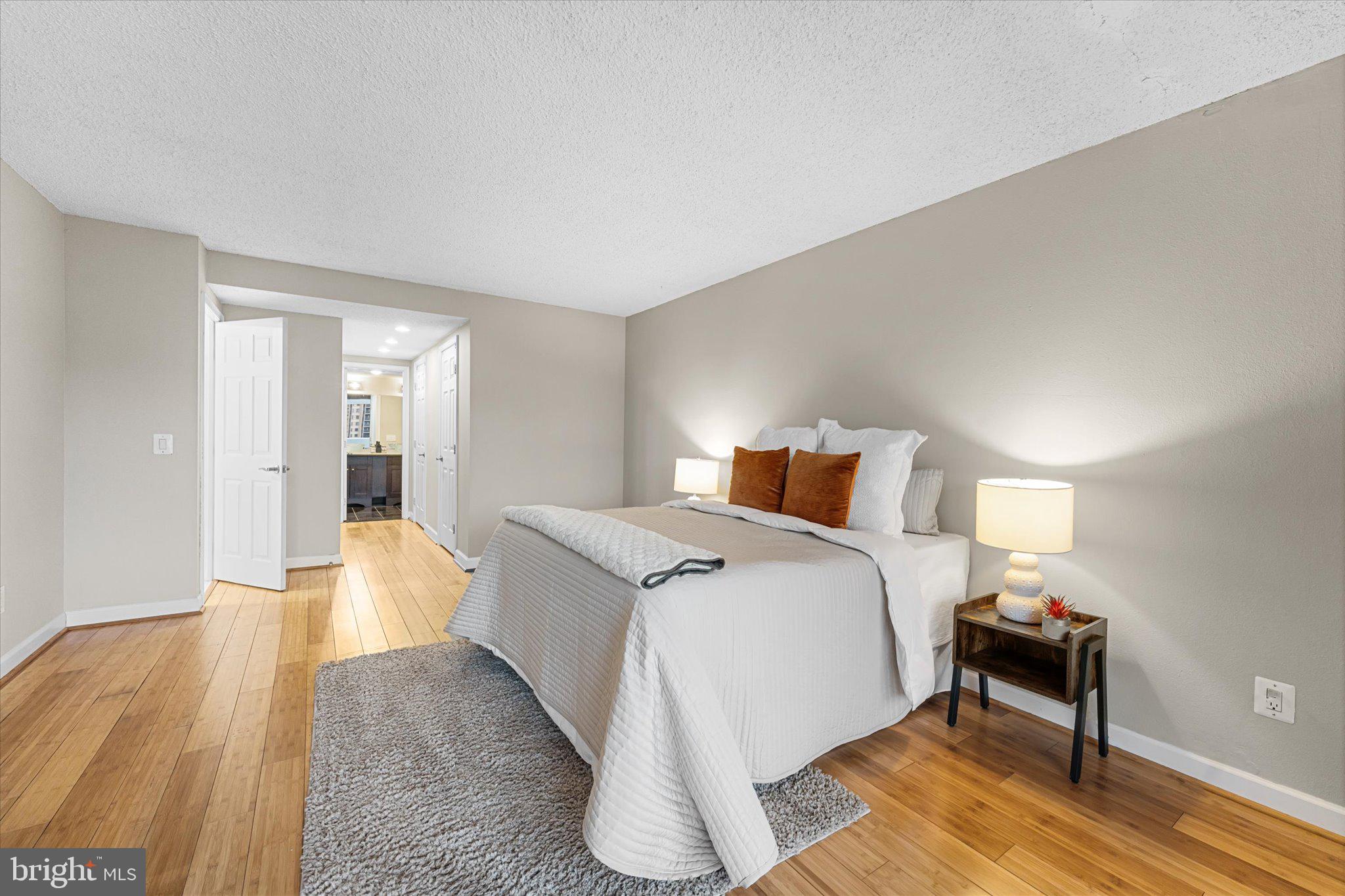 6101 Edsall Road, Unit 1402 Alexandria, VA 22304 - Photo 14 of 37 a bedroom with a bed and wooden floor