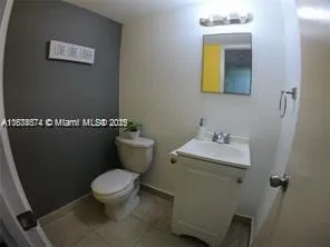 a white toilet sitting next to a bathroom sink