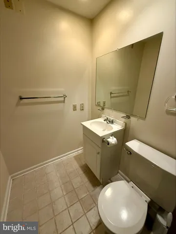 a bathroom with a sink a toilet and mirror
