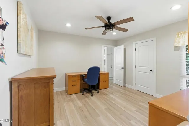 a view of a workspace with furniture and a window