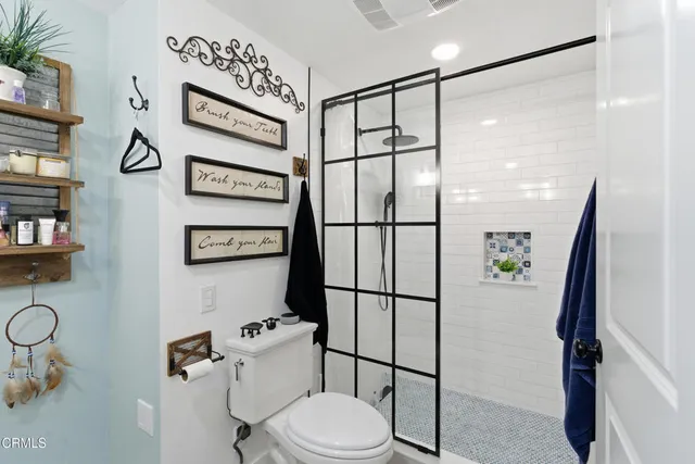a bathroom with a toilet sink and shower