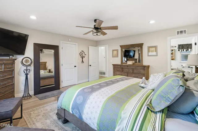 a spacious bathroom with a toilet a sink and a mirror
