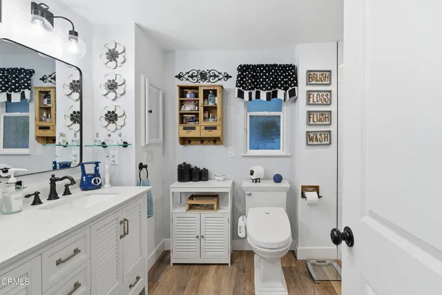 a bathroom with double vanity sinks and two mirror