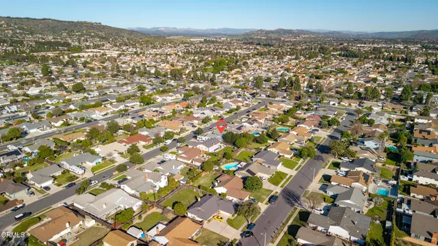 an aerial view of residential houses with city view