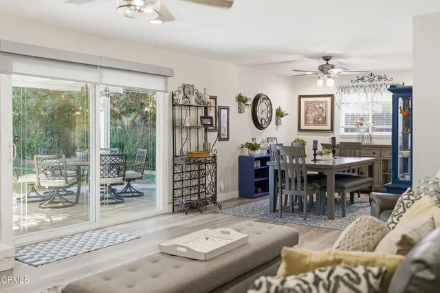 a living room with furniture a table and a large window
