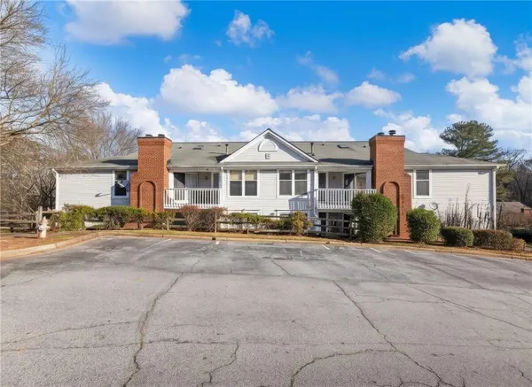 a front view of a house with a garden and pathway