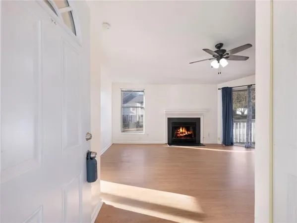 a view of a livingroom with a fireplace and a ceiling fan