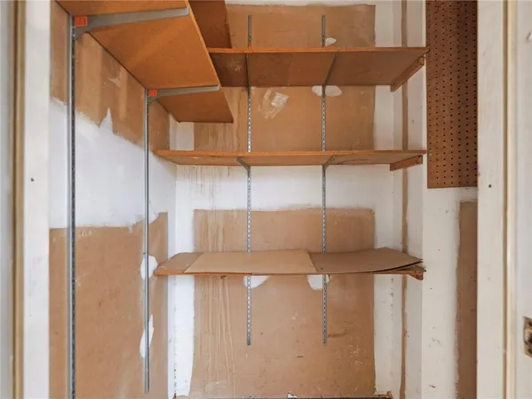 a view of a porch with a door and wooden floor