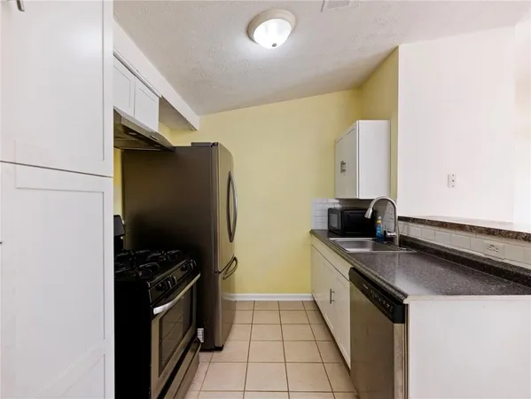 a kitchen with a sink appliances and cabinets