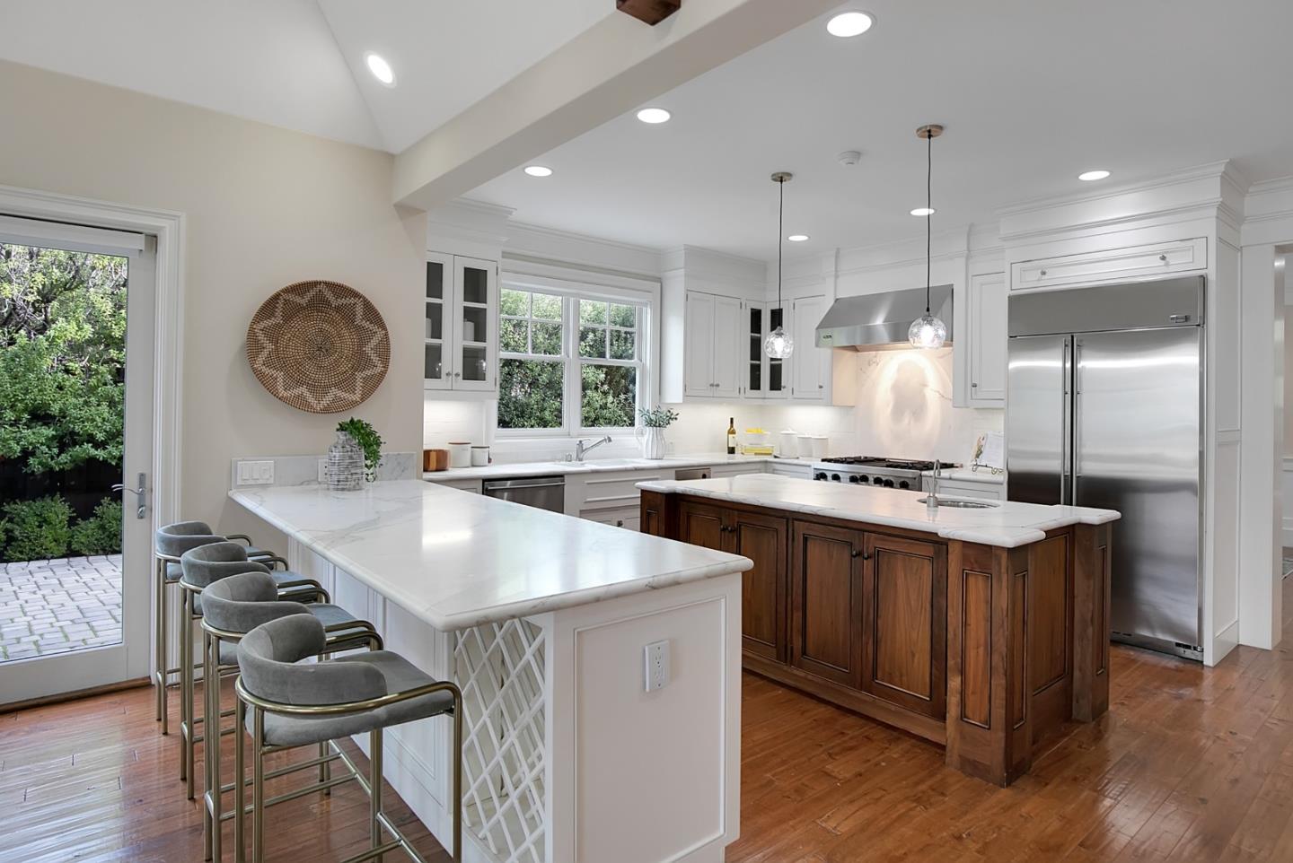 65 Maple Avenue Atherton, CA 94027 - Photo 16 of 45 a kitchen with stainless steel appliances granite countertop a sink a stove a refrigerator and island with wooden floor