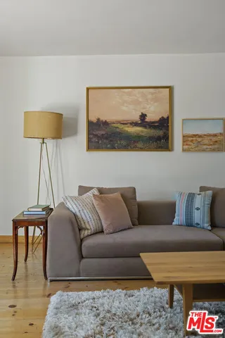 a living room with furniture and a lamp