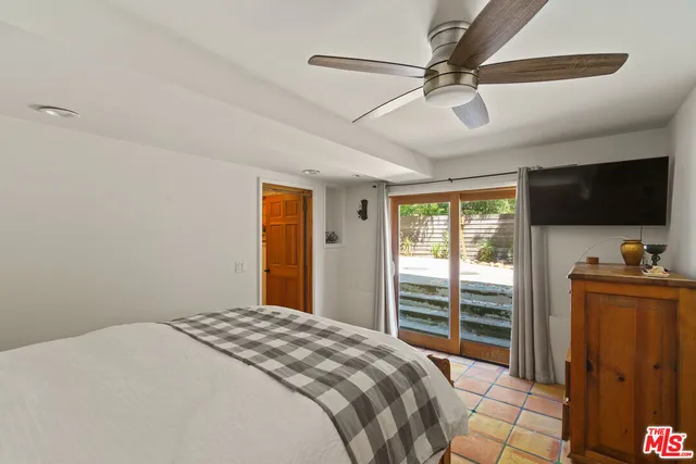 a bedroom with furniture and a window