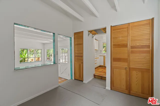 a kitchen with granite countertop a sink stove and refrigerator