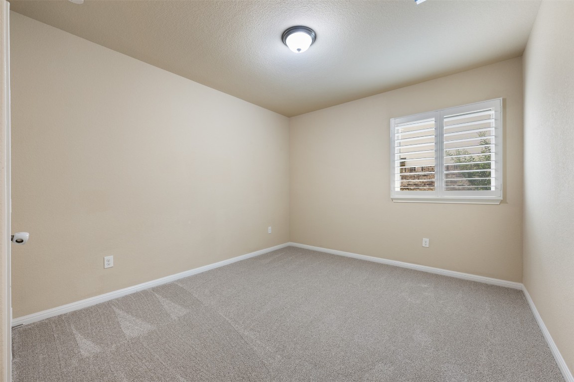 533 Flag Lane Leander, TX 78641 - Photo 21 of 40 Secondary downstairs bedroom 3 with newly installed carpet and plantation shutters.