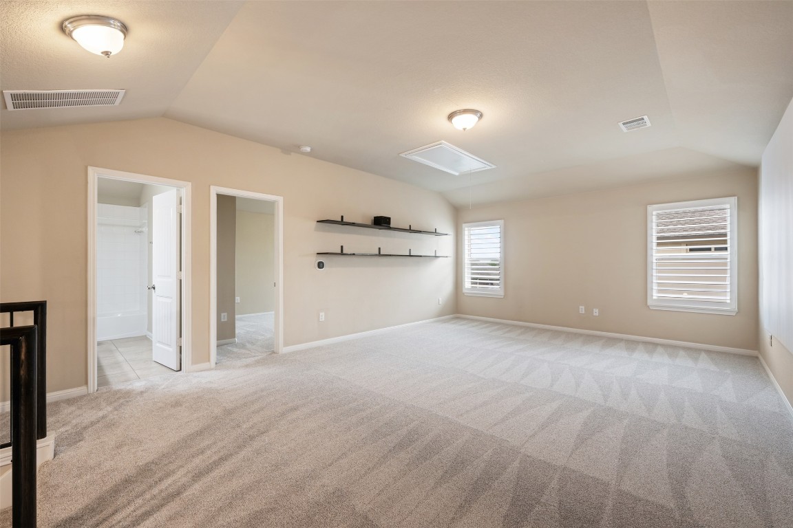 533 Flag Lane Leander, TX 78641 - Photo 25 of 40 Game room with projector and screen, plantation shutters, newly installed carpet, doors to the left are a full bath with bedroom #4