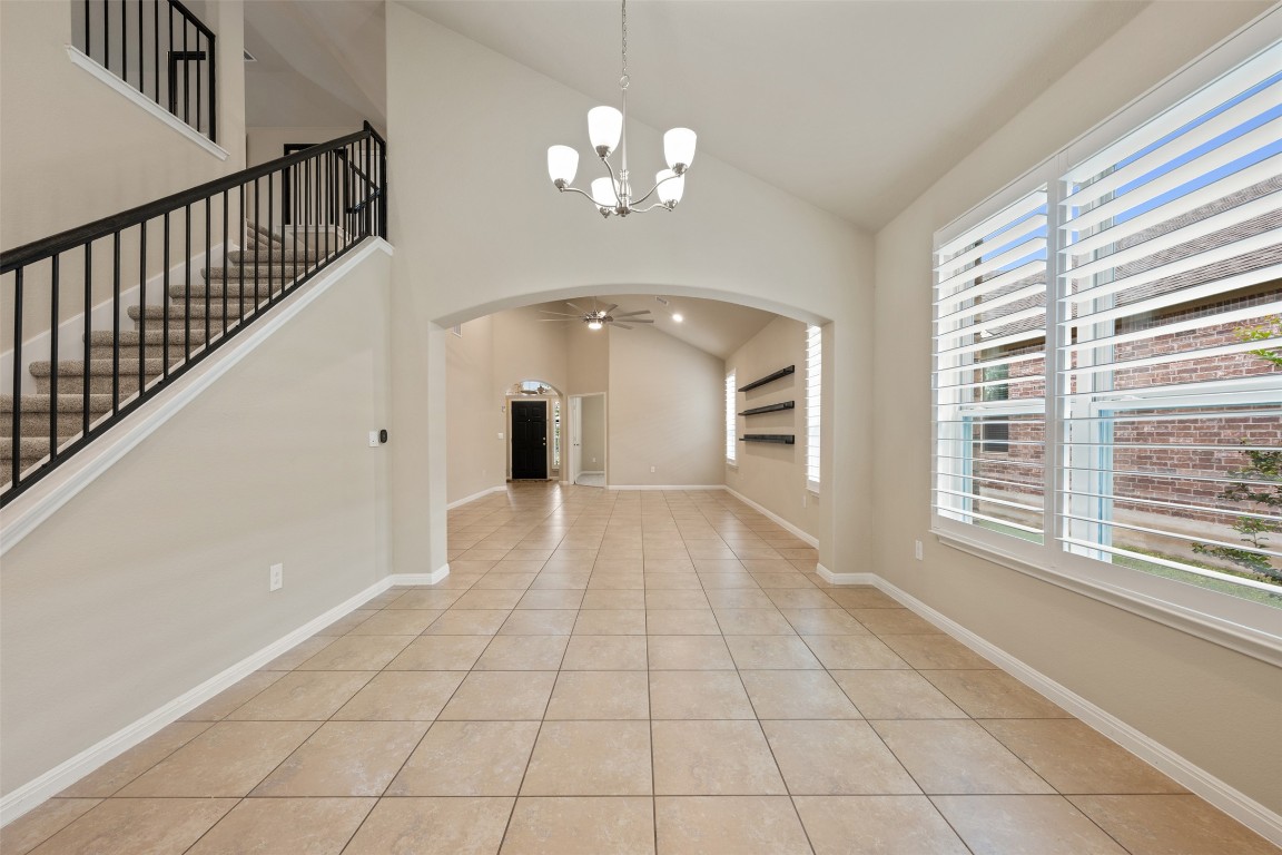 533 Flag Lane Leander, TX 78641 - Photo 10 of 40 Arched walkways, vaulted ceiling, a chandelier,seemless tile flooring, and plenty of natural light