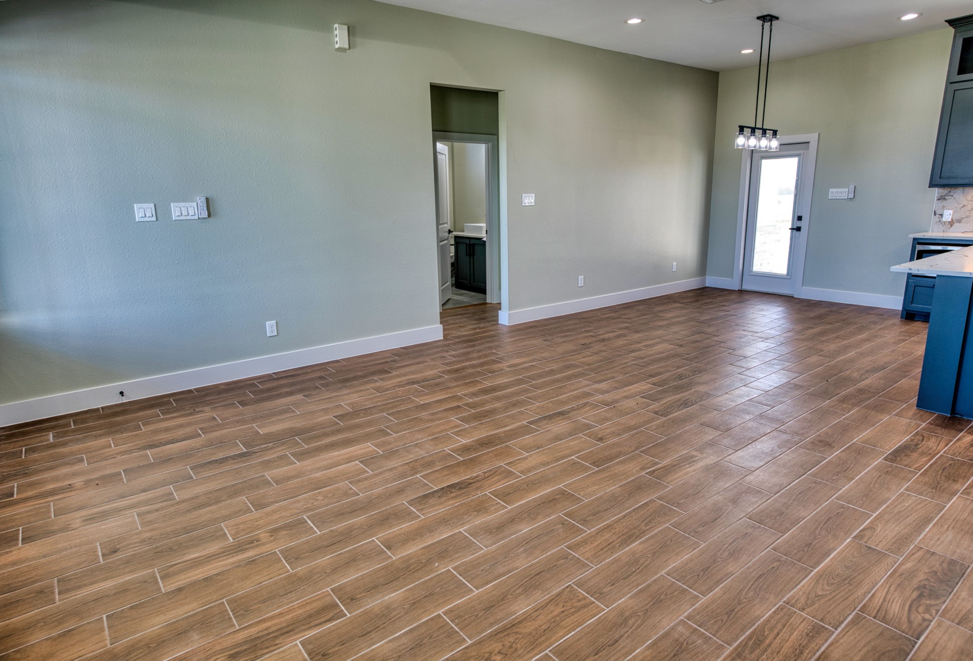 925 Buffalo Trail Angleton, TX 77515 - Photo 16 of 45 an empty room with wooden floor and windows