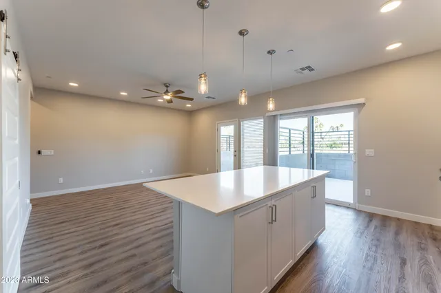 a kitchen with white cabinets and appliances