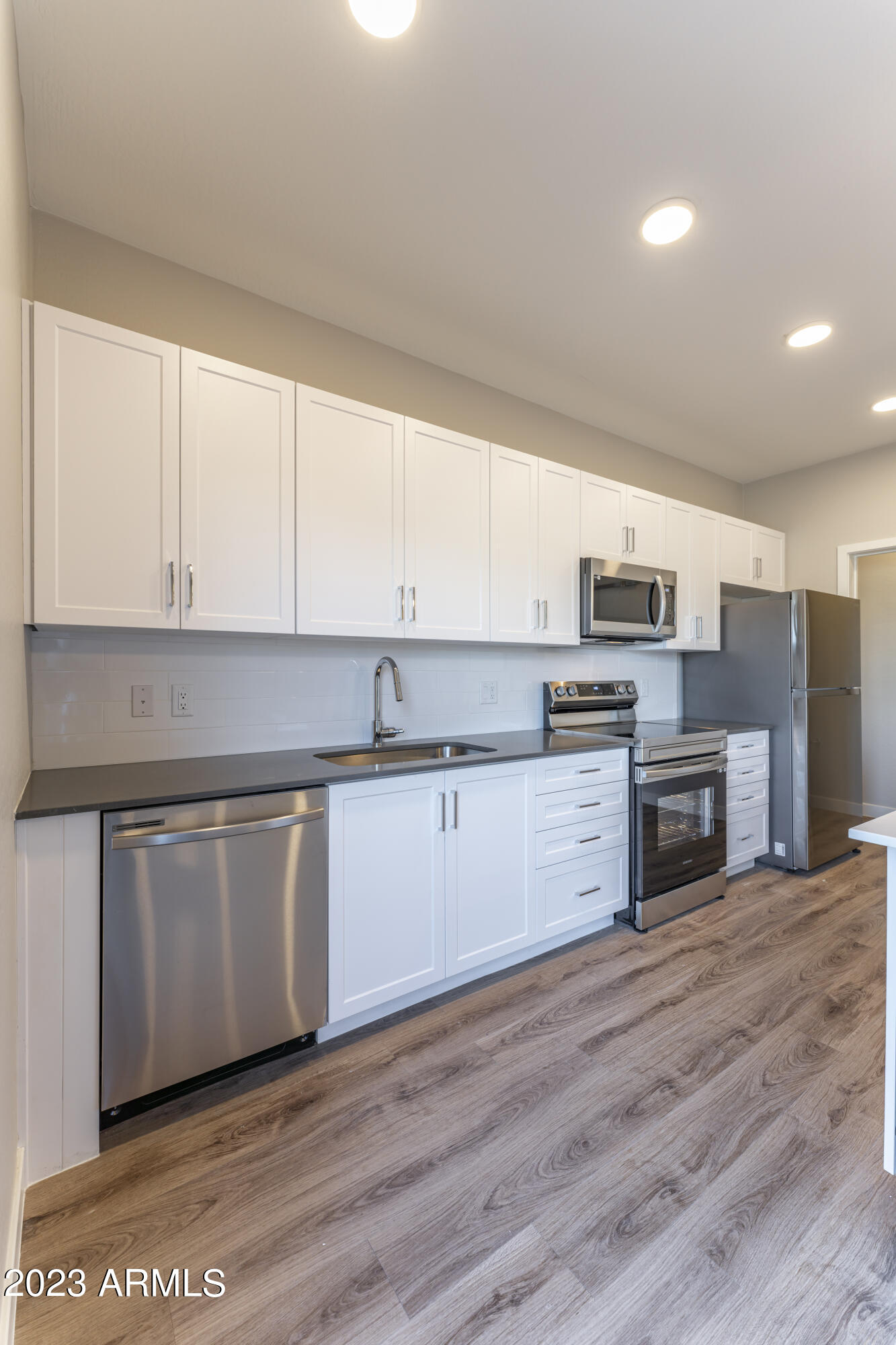 432 South 32nd Street, Unit 114 Mesa, AZ 85204 - Photo 13 of 75 a kitchen with stainless steel appliances granite countertop a stove a sink and white cabinets