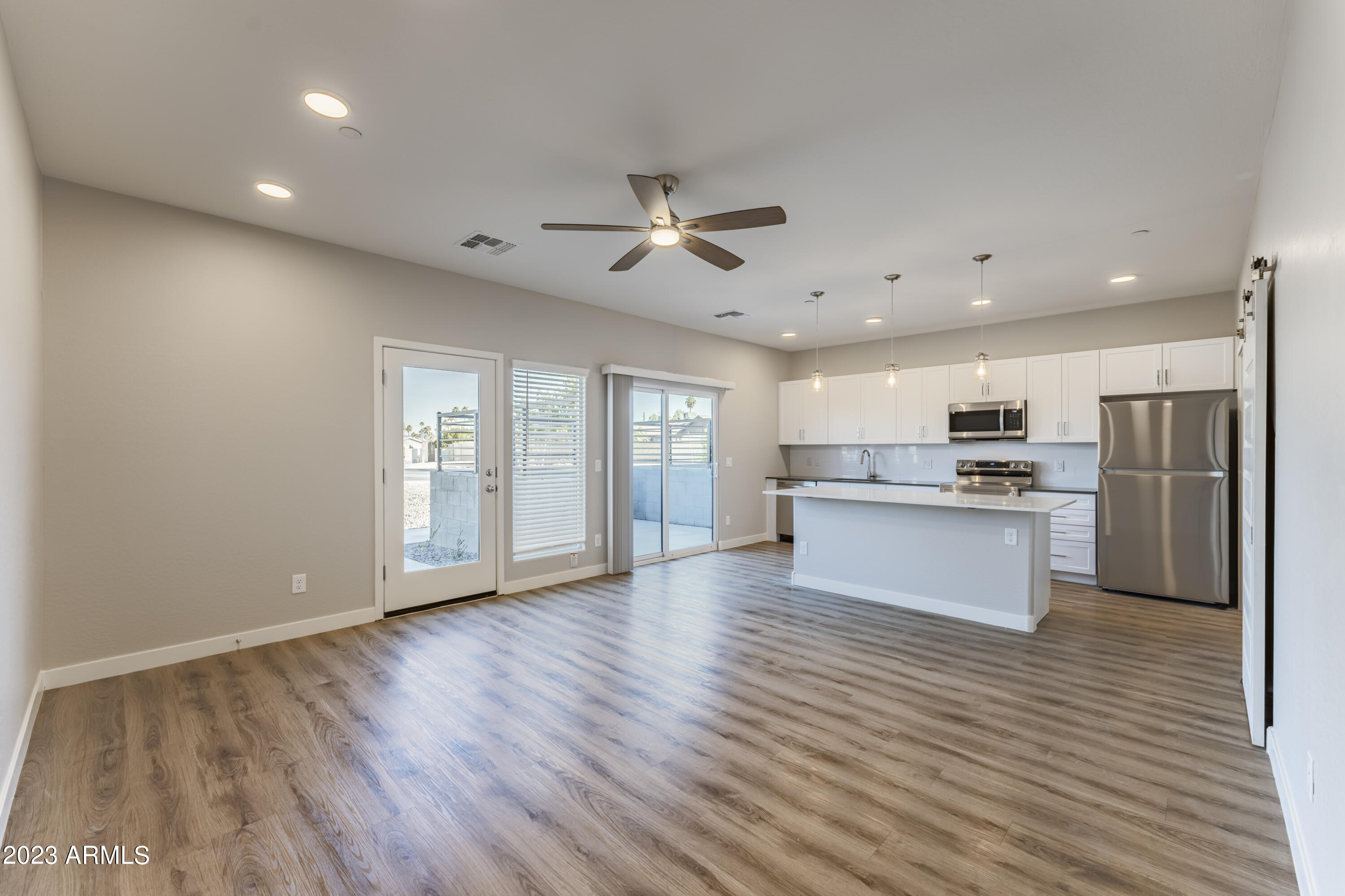 432 South 32nd Street, Unit 114 Mesa, AZ 85204 - Photo 9 of 75 a view of kitchen with refrigerator microwave and stove with wooden floor