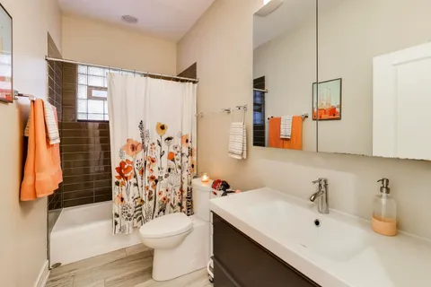 a bathroom with a sink toilet and shower