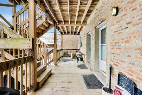 a view of a porch with wooden floor and windows