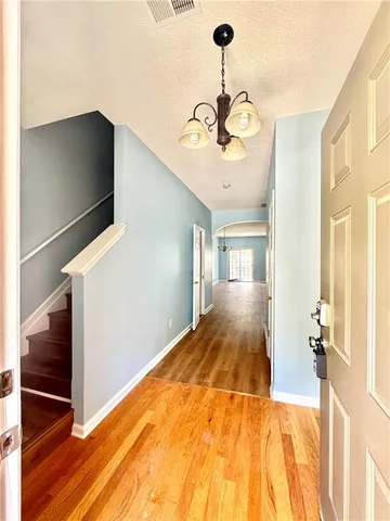 a view of a hallway with a chandelier