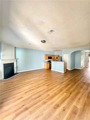 a view of empty room with a fireplace