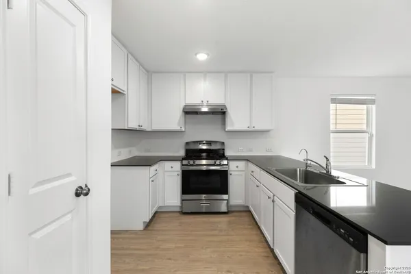 a kitchen with a sink and cabinets