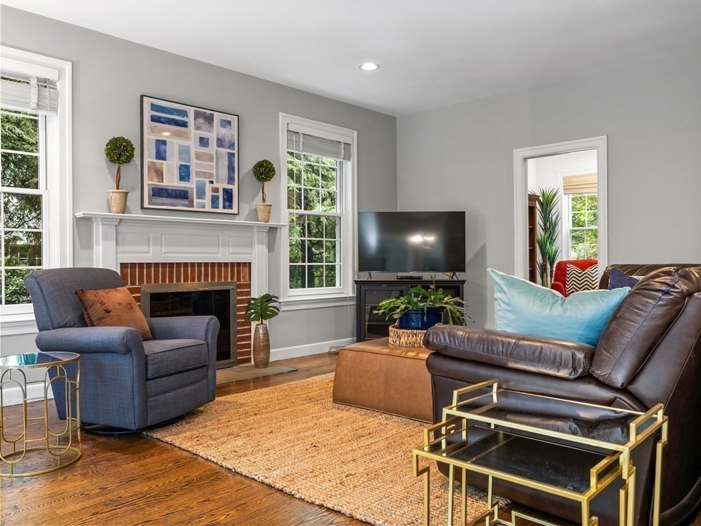 34 Upwey Road Wellesley, MA 02481 - Photo 11 of 19 a living room with furniture a large window and a fireplace