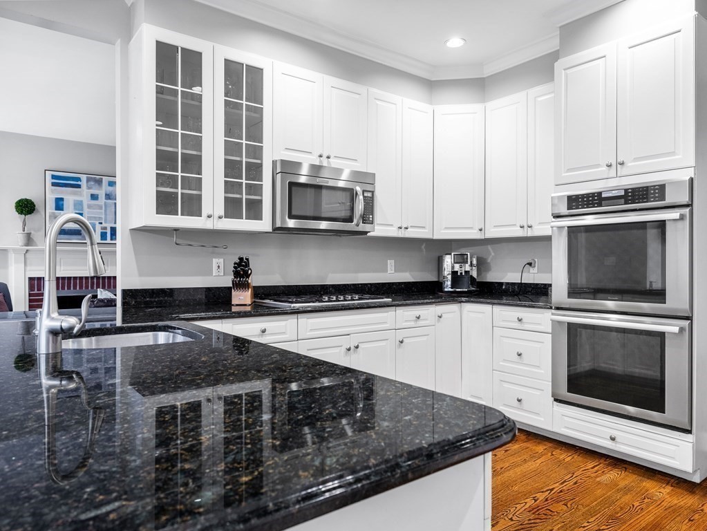 34 Upwey Road Wellesley, MA 02481 - Photo 6 of 19 a kitchen with stainless steel appliances granite countertop a stove a sink and a microwave