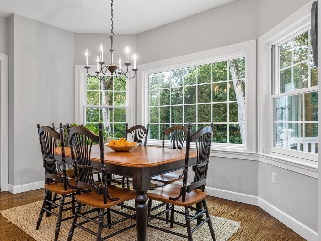 34 Upwey Road Wellesley, MA 02481 - Photo 9 of 19 a dining room with furniture large windows and a chandelier
