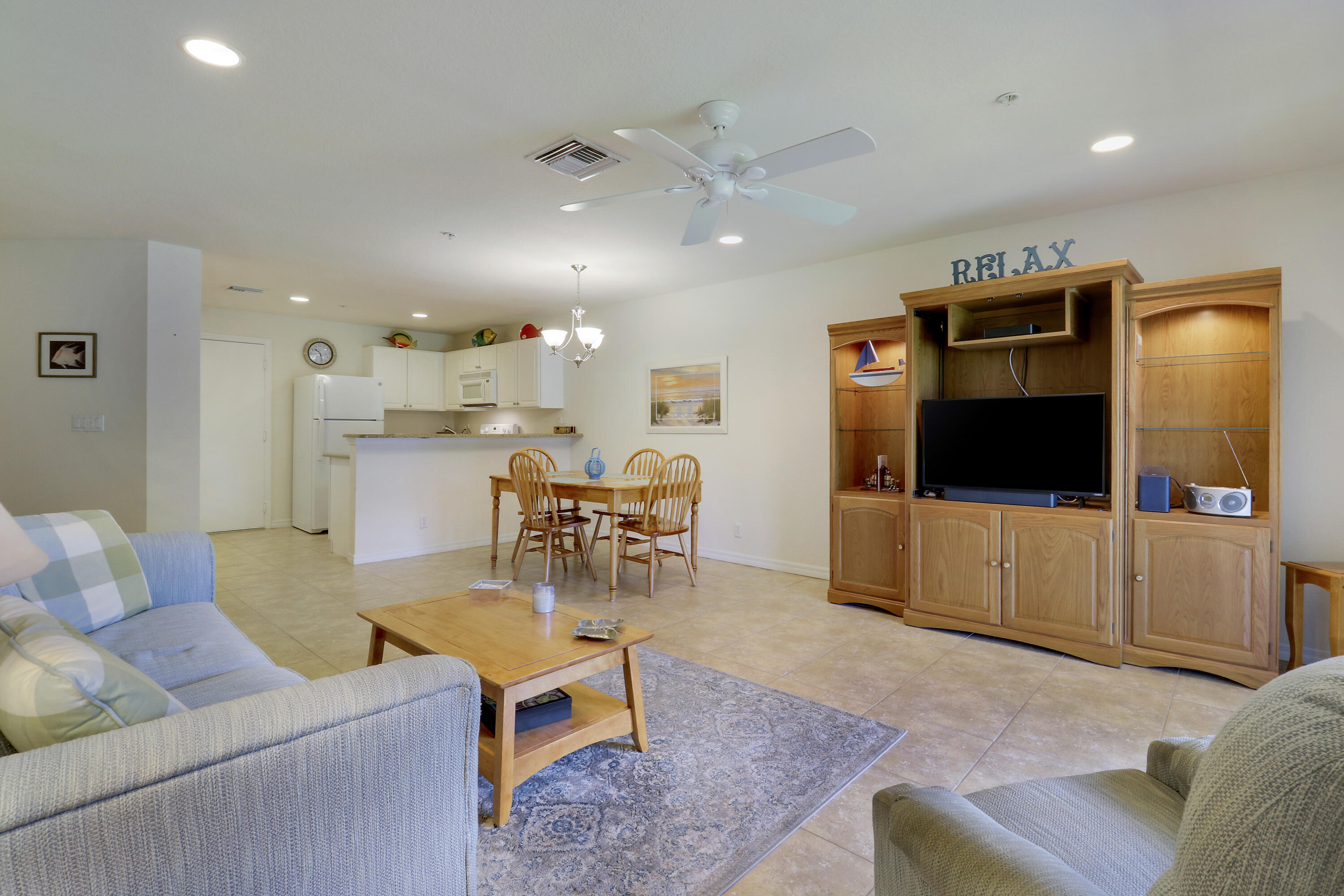 5410 Southeast Mitchell Lane Stuart, FL 34997 - Photo 11 of 24 a living room with furniture and a flat screen tv