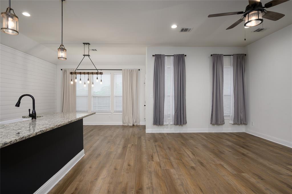 300 Bronco Drive Pilot Point, TX 76258 - Photo 11 of 31 a view of a kitchen with wooden floor and stainless steel appliances