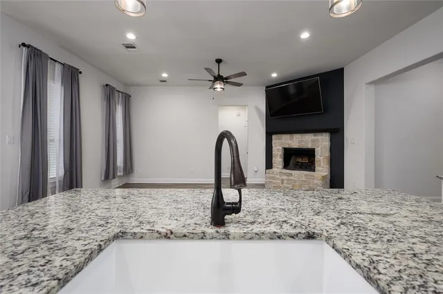 a view of a kitchen with a sink and a refrigerator