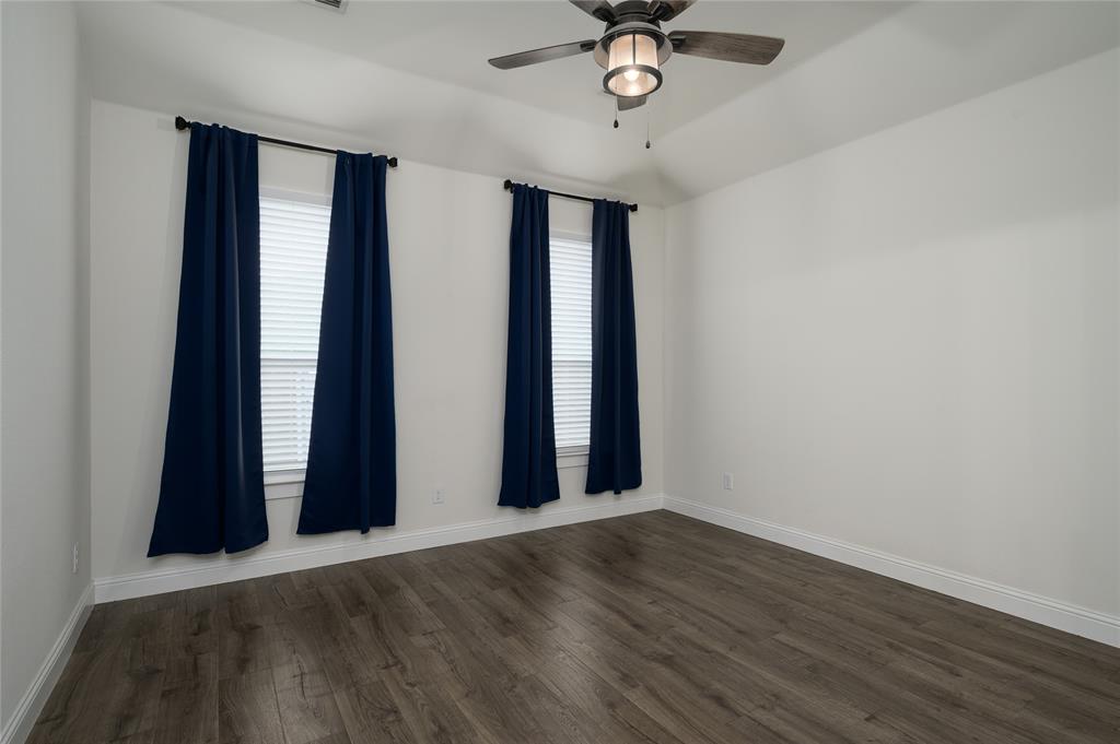 300 Bronco Drive Pilot Point, TX 76258 - Photo 18 of 31 an empty room with wooden floor and windows