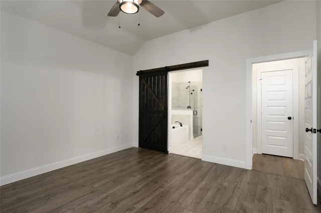 an empty room with wooden floor and cabinet