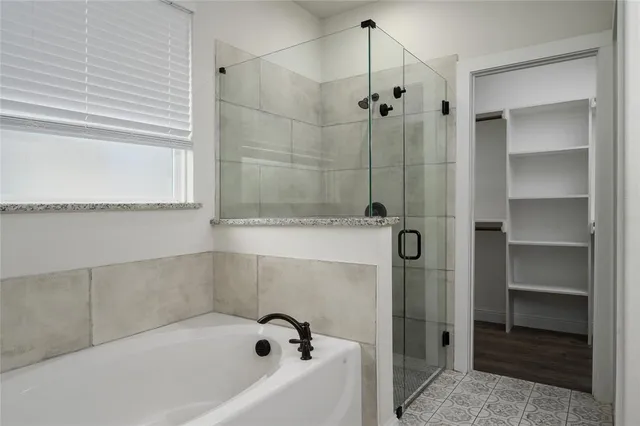 a bathroom with a bathtub and a shower