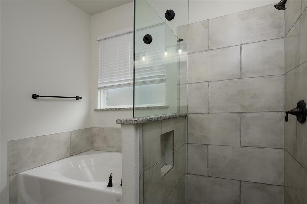 300 Bronco Drive Pilot Point, TX 76258 - Photo 22 of 31 a bathroom with a bathtub and a shower