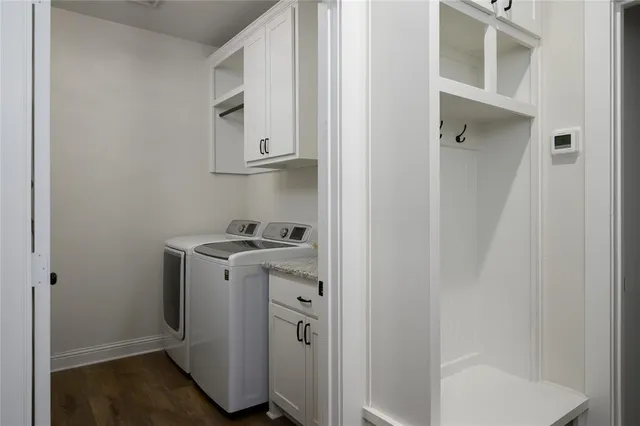 a utility room with wooden floor cabinetry and a sink
