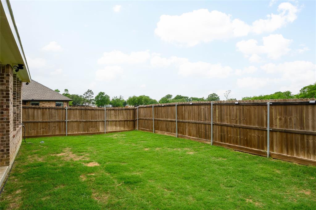300 Bronco Drive Pilot Point, TX 76258 - Photo 29 of 31 a view of a backyard with a fence