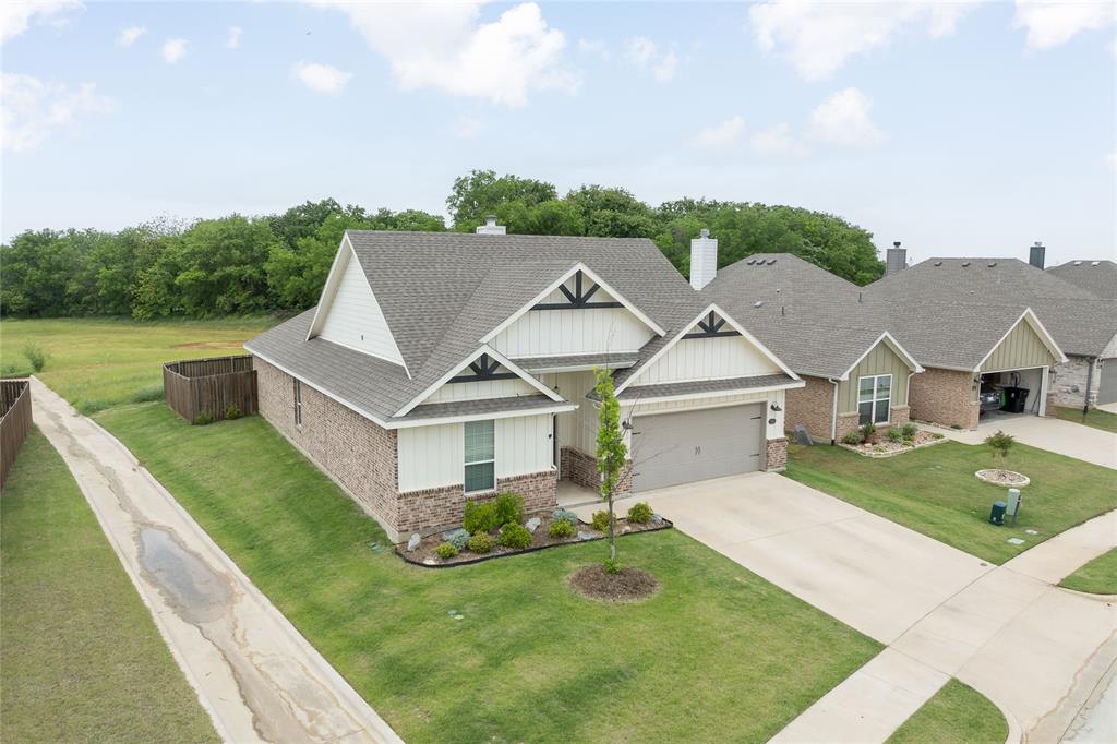 300 Bronco Drive Pilot Point, TX 76258 - Photo 4 of 31 a front view of a house with garden