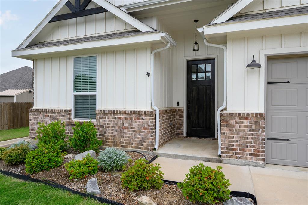 300 Bronco Drive Pilot Point, TX 76258 - Photo 5 of 31 a front view of a house with a garden