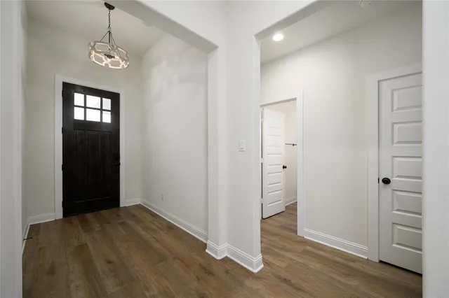 a view of a room with wooden floor and closet