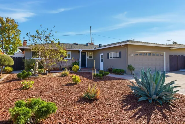 a front view of a house with garden